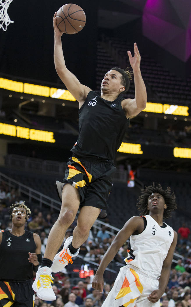 Cole Anthony (50) slices to the rim past Tyrese Maxey (3) in the first half during the Jordan B ...