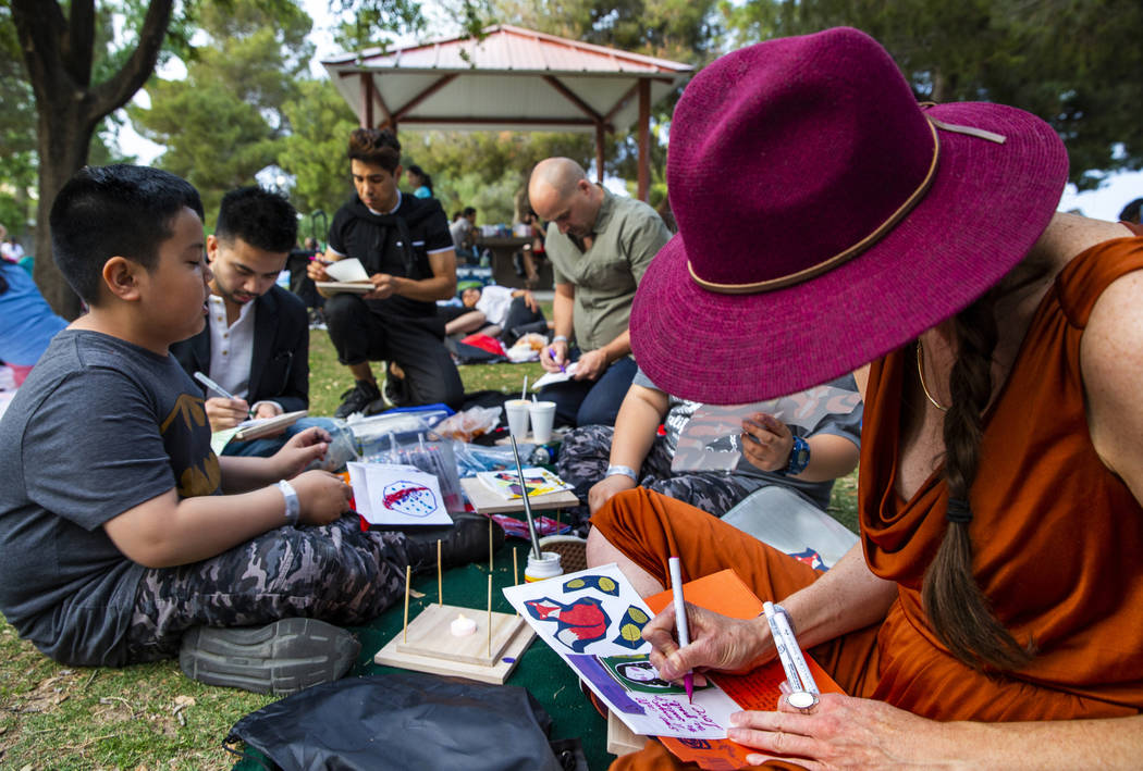 Charlotte Fox and friends decorate their lanterns during the Water Lantern Festival at Sunset P ...