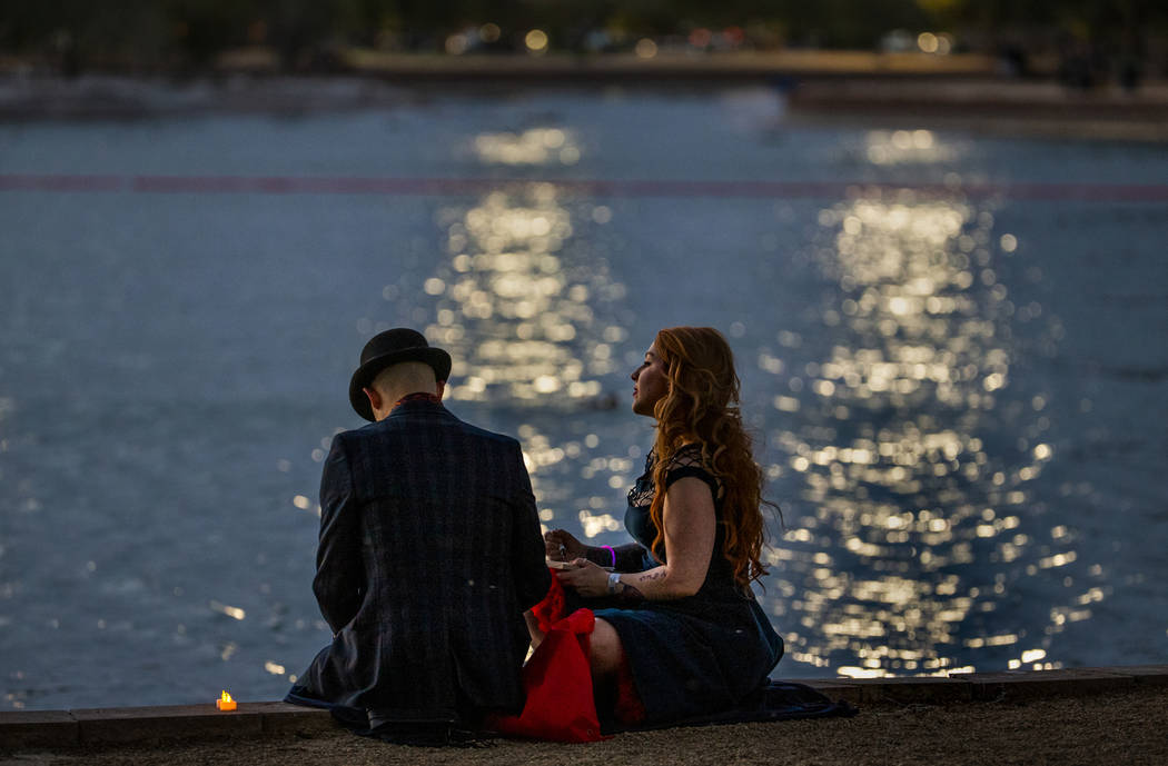 Justin Avila and Alexis Sutherland wait for the lantern launching to being during the Water Lan ...