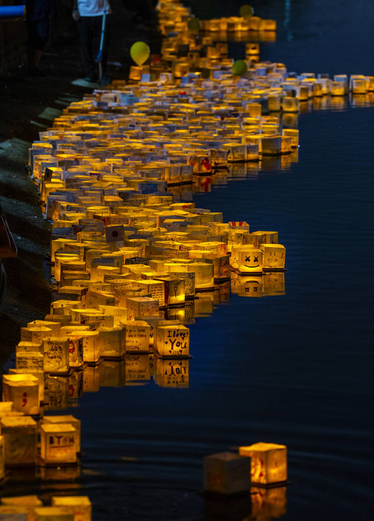 Lanterns gather near the shore during the Water Lantern Festival at Sunset Park on Saturday, Ap ...