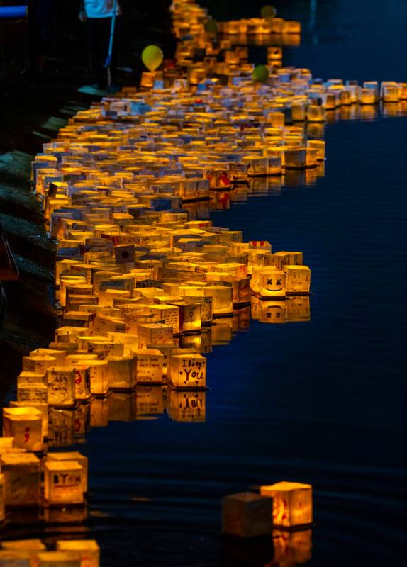 Lanterns gather near the shore during the Water Lantern Festival at Sunset Park on Saturday, Ap ...