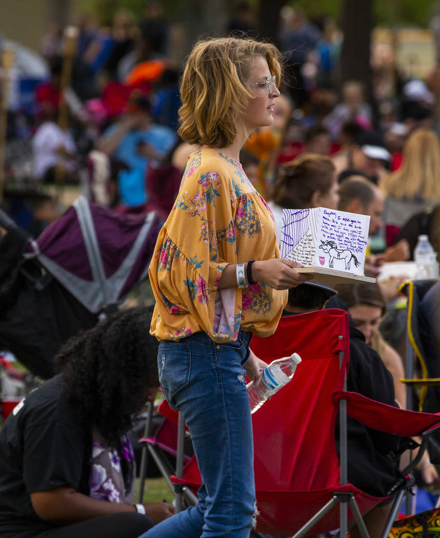 A participant makes her way to the lake with a lantern during the Water Lantern Festival at Sun ...