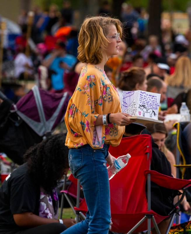 A participant makes her way to the lake with a lantern during the Water Lantern Festival at Sun ...