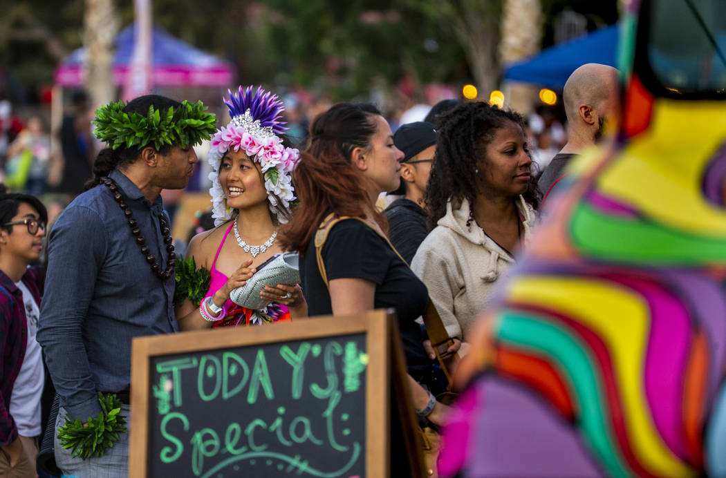 Vincent Rinaldi and Saraswati Queen Goddess join others in ordering food truck tacos during the ...