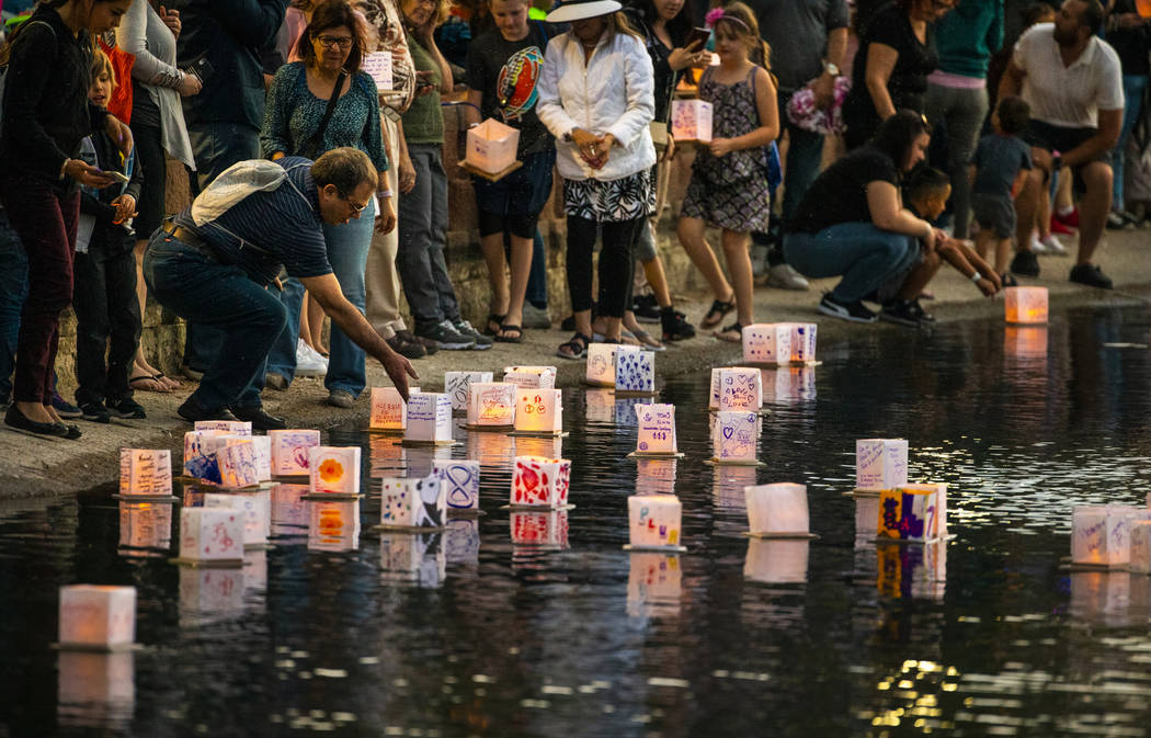 Participants gather at the lake edge to launch their lanterns during the Water Lantern Festival ...