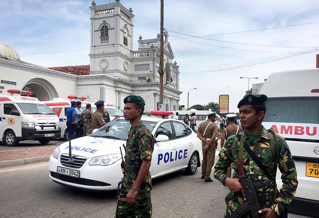 Sri Lankan Army soldiers secure the area around a church after a blast in Colombo, Sri Lanka, S ...