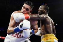 Terence Crawford, right, punches England's Amir Khan during the fifth round of a WBO world welt ...