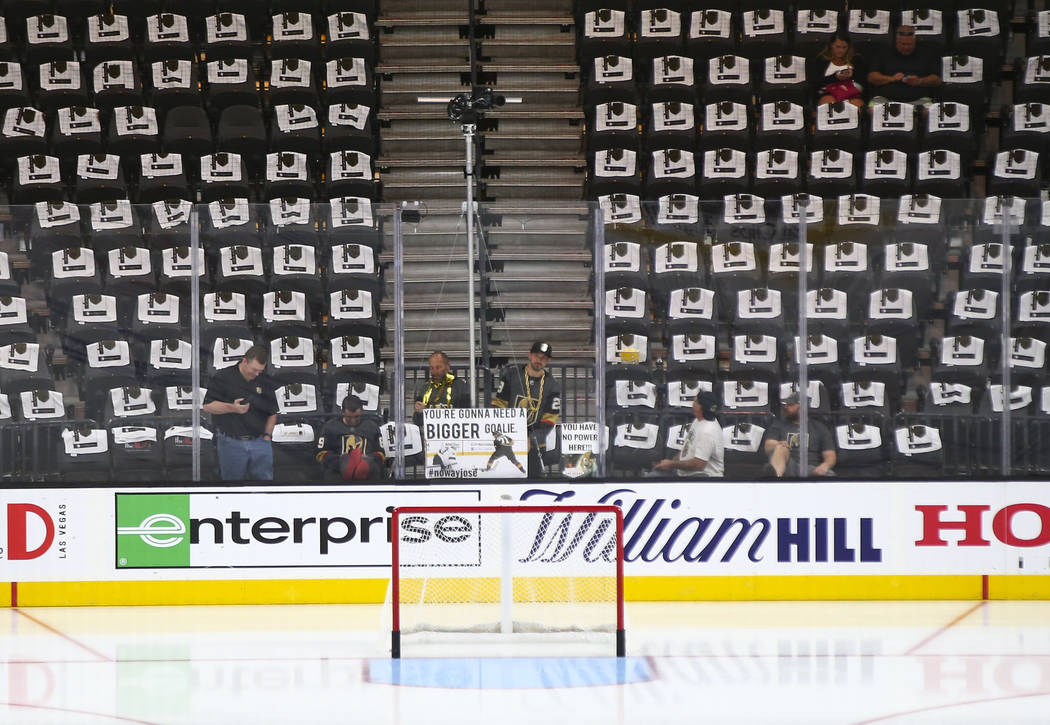 A Golden Knights fan holds up a sign saying "you're gonna need a bigger goalie" befor ...
