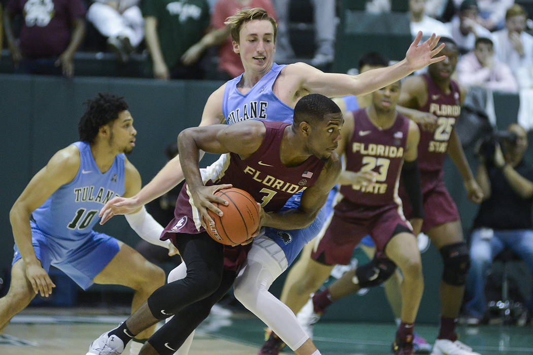 Florida State guard Trent Forrest (3) runs with the ball against Tulane guard Moses Wood during ...