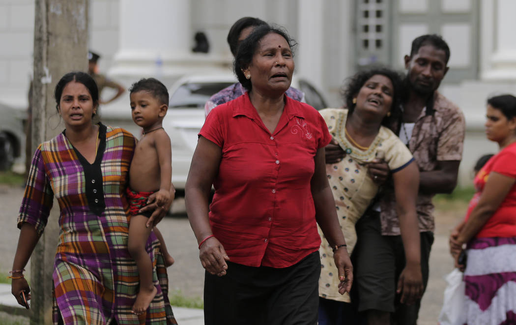 Relatives of a blast victim grieve outside a morgue in Colombo, Sri Lanka, Sunday, April 21, 20 ...