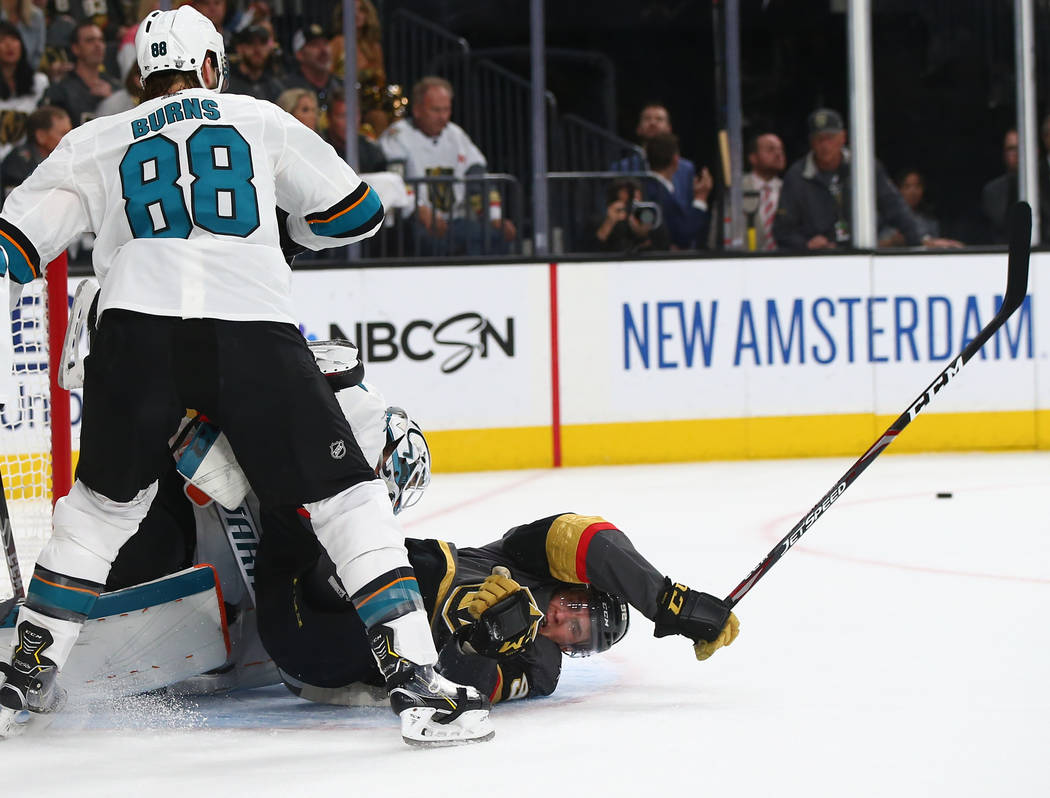 Golden Knights left wing Tomas Nosek (92) gets tripped up in front of San Jose Sharks goaltende ...