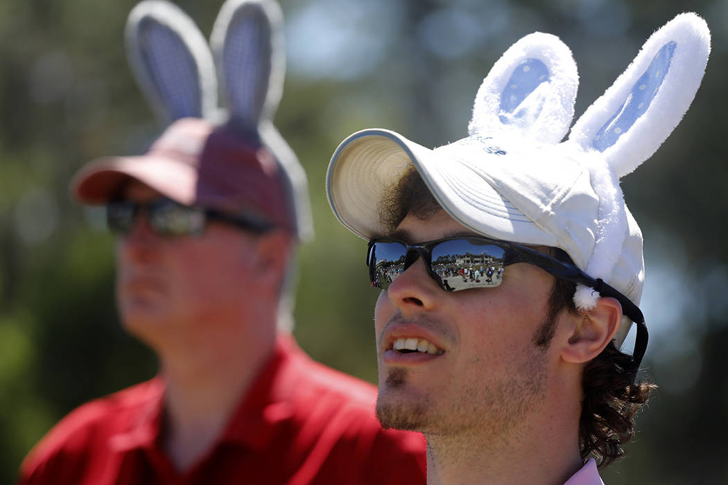Zach Kurtz, at right, and his father Tom Kurtz, both from Cincinnati, wear Easter Bunny ears as ...