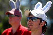 Zach Kurtz, at right, and his father Tom Kurtz, both from Cincinnati, wear Easter Bunny ears as ...