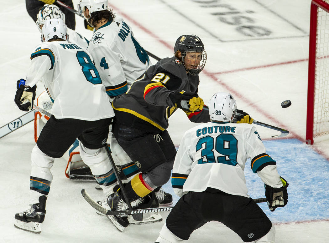 Golden Knights defenseman Shea Theodore (27) nearly taps a goal in as San Jose Sharks center Lo ...