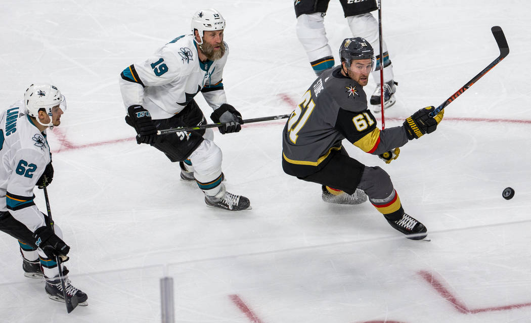 Golden Knights right wing Mark Stone (61) eyes a loose puck with San Jose Sharks center Joe Tho ...