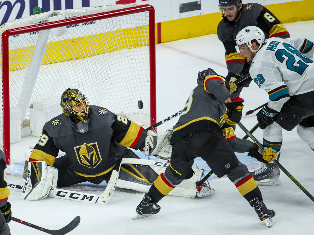Golden Knights goaltender Marc-Andre Fleury (29) looks to a loose puck deflected by San Jose Sh ...