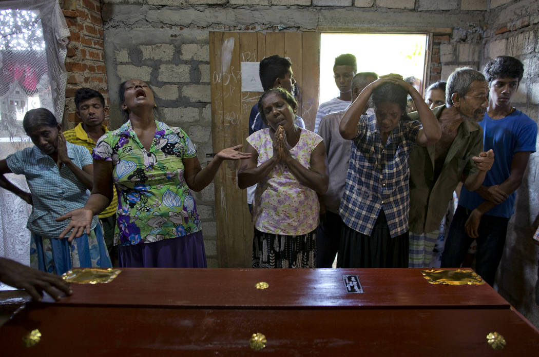 Relatives weep near the coffin with the remains of 12-year Sneha Savindi, who was a victim of E ...