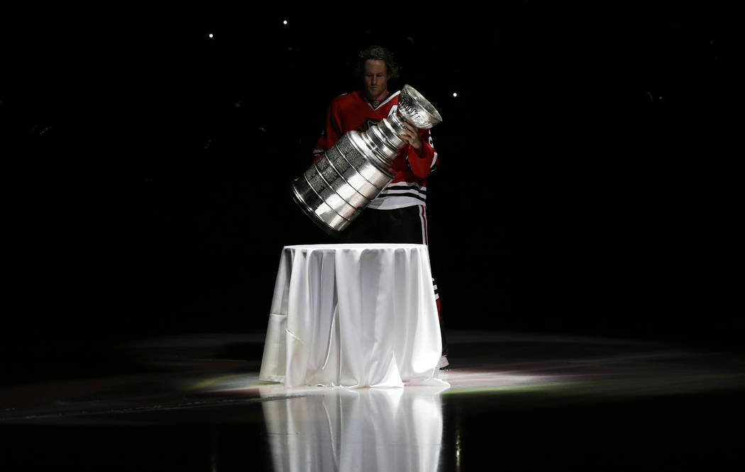 In this Oct. 1, 2013, photo, Chicago Blackhawks defenseman Duncan Keith carries out the Stanley ...