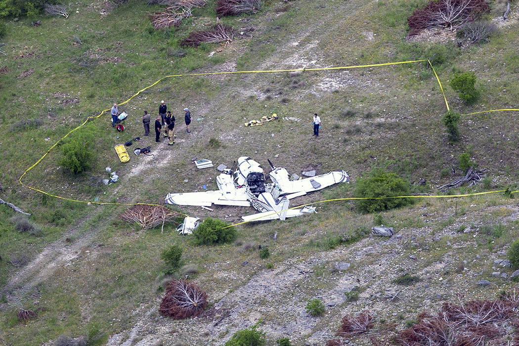 Authorities investigate at the crash scene of a twin-engine Beechcraft BE58, Monday, April 22, ...