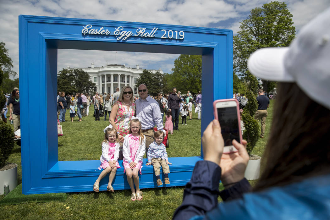 Guests take photos at the annual White House Easter Egg Roll on the South Lawn of the White Hou ...