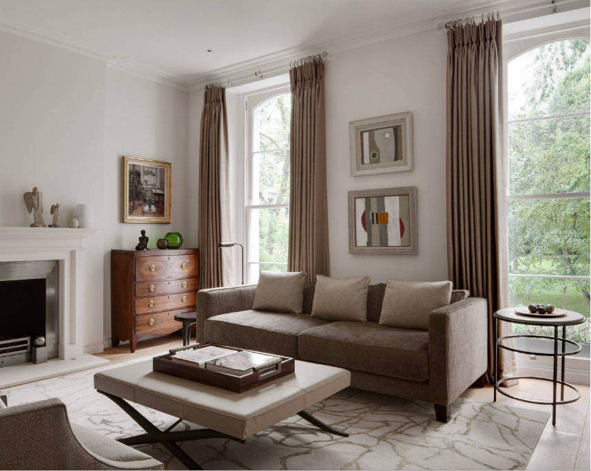 There are two different tables on each side of the sofa, one larger than the other. (Houzz)