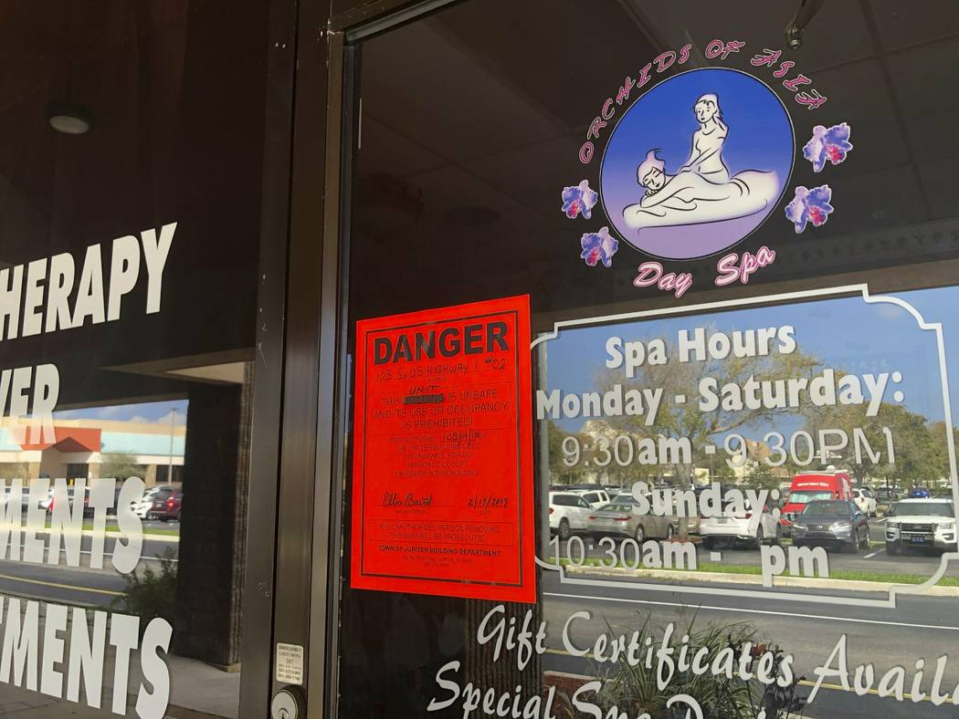 A sign is posted outside of Orchids of Asia Day Spa, Friday, Feb. 19 ,2019, in Jupiter, Fla. Ju ...