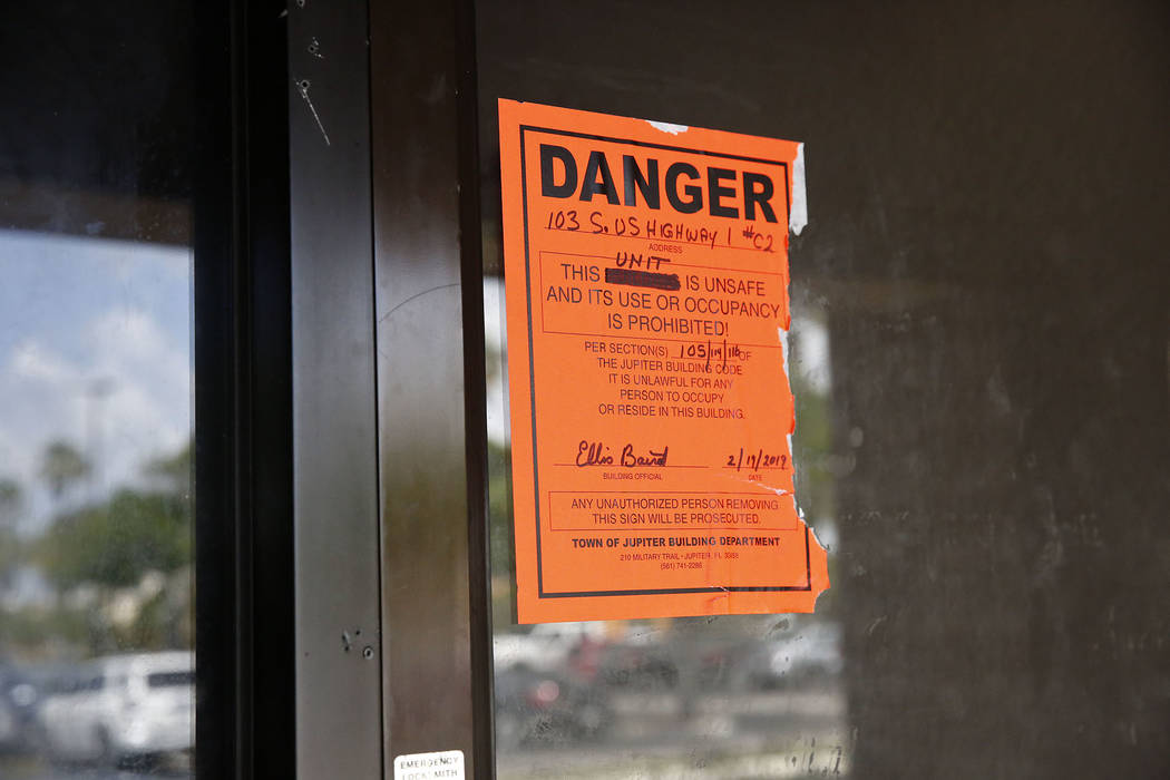 An orange danger sign is seen posted outside on the front entrance of the Orchids of Asia Day S ...