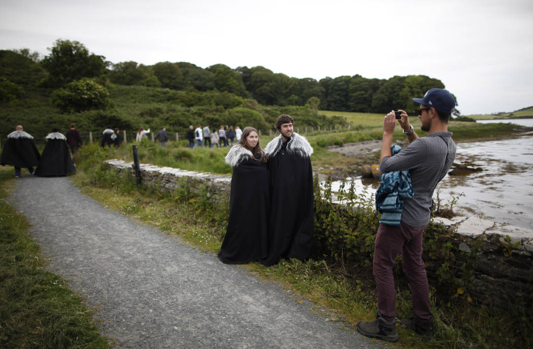 FILE- In this June 13, 2014, file photo "Game of Thrones" fans stop for a picture on ...