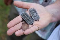 FILE - In this Aug. 3, 2017, file photo, the dog tags and a Hawaiian pressed penny charm of Pfc ...