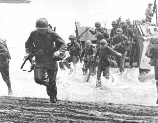 FILE - In this Aug. 1942 file photo, U.S. Marines charge ashore on Guadalcanal Island from a la ...