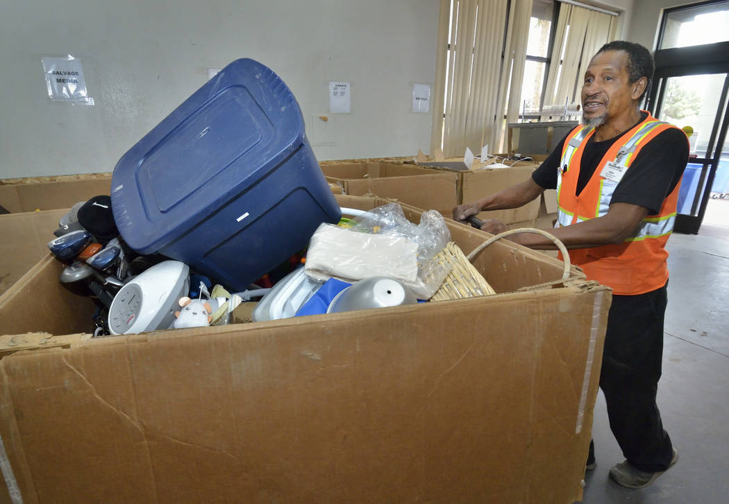 Donation attendant Ulysses Hampton moves merchandise in the warehouse at the Goodwill Thrift St ...