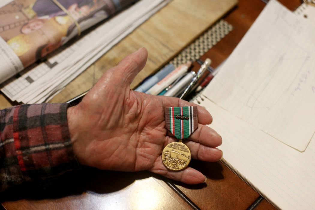 Onofrio "No-No" Zicari, 96, shows the the Review-Journal a medal he earned for his th ...