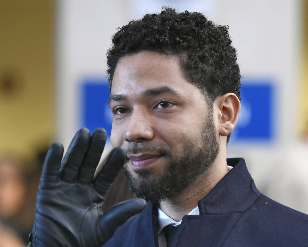 FILE - In this March 26, 2019, file photo, actor Jussie Smollett smiles and waves to supporters ...