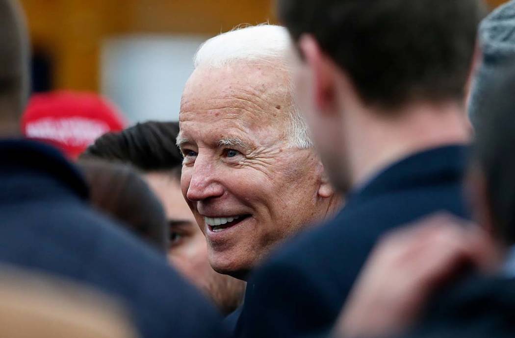 Former vice president Joe Biden talks with officials after speaking at a rally in support of st ...