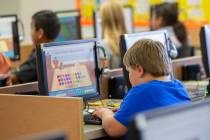 Students work on computers at an elementary school Oct. 29, 2018, in Beaver, Utah. According to ...