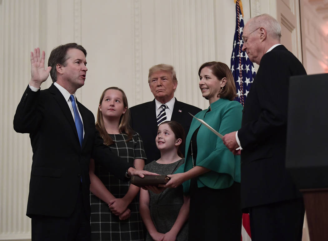 Retired Justice Anthony Kennedy, right, ceremonially swears-in Supreme Court Justice Brett Kava ...
