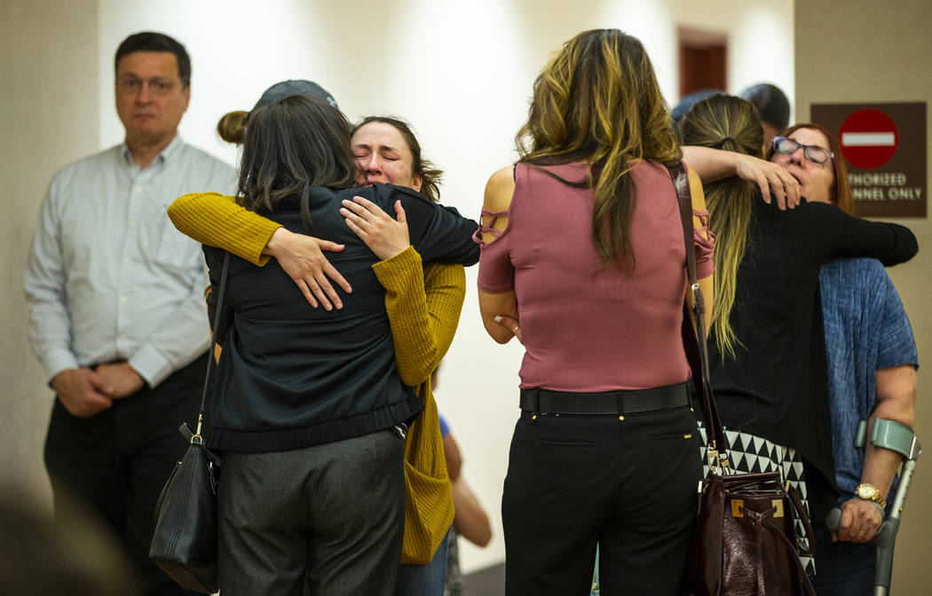 Family members and supporters comfort each other after former Metro officer Pamela Bordeaux, ch ...
