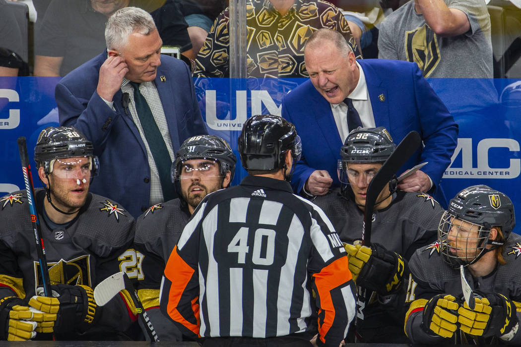 Golden Knights Head Coach Gerard Gallant argues a point with a referee during the first period ...