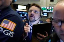 Trader Michael Milano works on the floor of the New York Stock Exchange on March 12, 2019. (AP ...