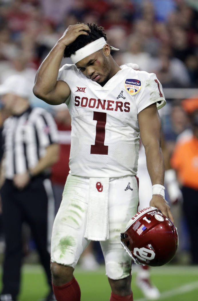 Oklahoma quarterback Kyler Murray (1) walks off the field after his helmet came off on a play, ...
