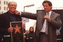 Actor Sylvester Stallone, right, lands a mock punch on the chin of producer Irwin Winkler durin ...