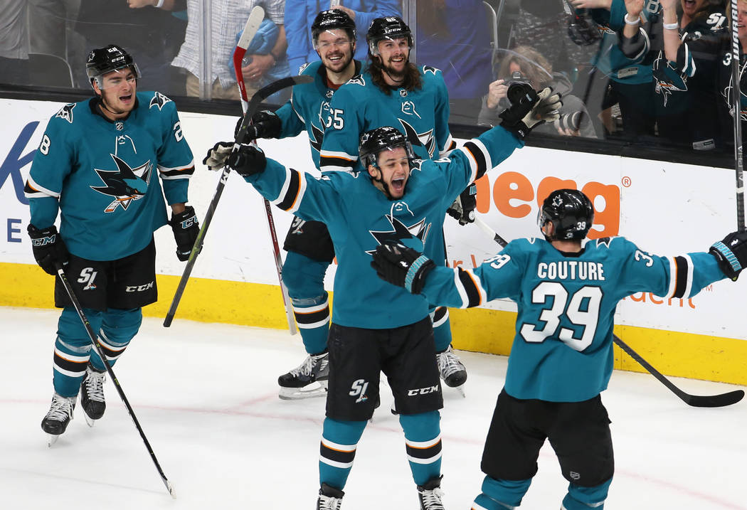 Sharks right wing Kevin Labanc (62) celebrates with Sharks center Logan Couture (39) after the ...