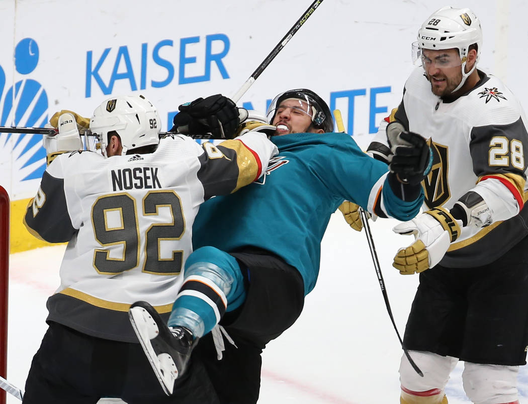 Knights left wing Tomas Nosek (92) punches Sharks defenseman Brenden Dillon (4) in the second p ...