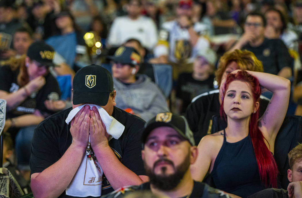 Golden Knights fans Michael and Rebecca Moore sit dismayed as the San Jose Sharks go up 4-3 dur ...