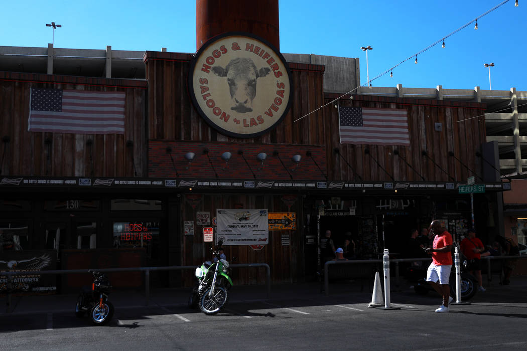 A passerby walks past Hogs & Heifers in Las Vegas on Tuesday, May 15, 2018. The city is pro ...