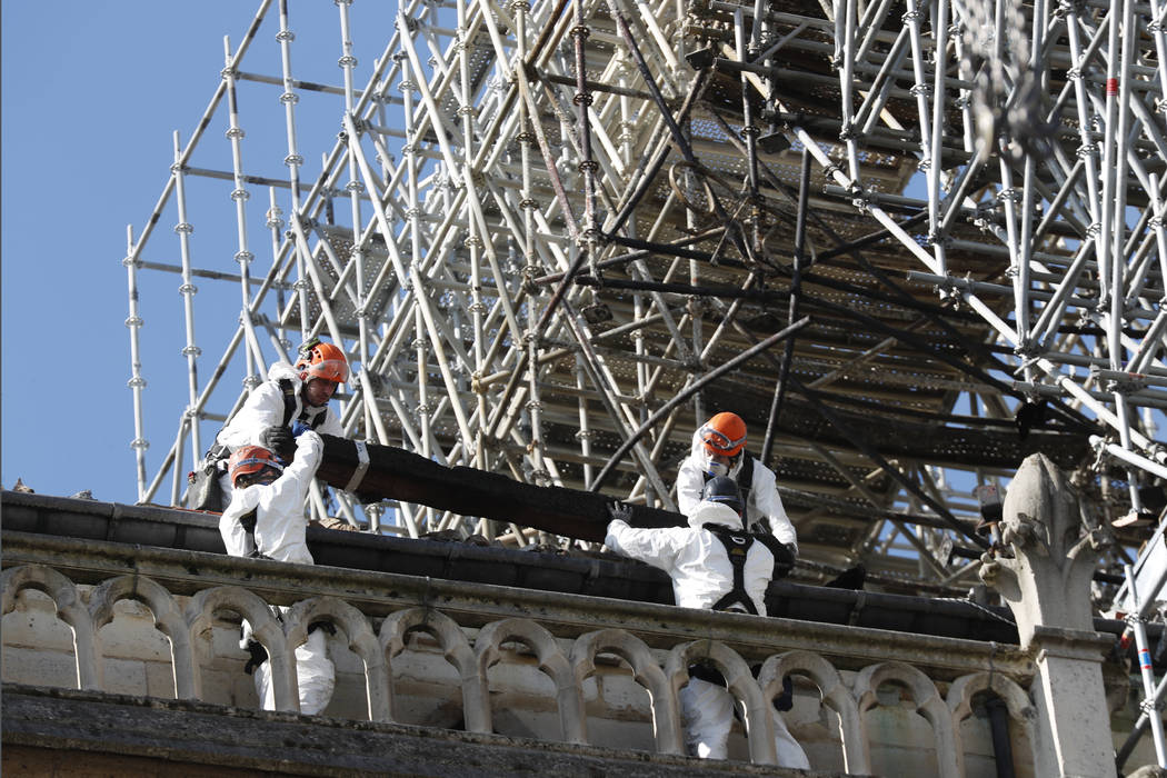 Workers install protections on Notre Dame cathedral Wednesday, April 24, 2019 in Paris. Profess ...