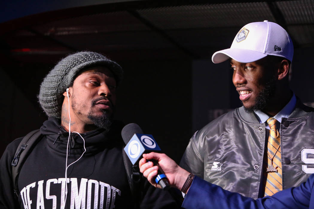 Josh Johnson watches as his cousin and NFL player Marshawn Lynch is interviewed during the Alli ...