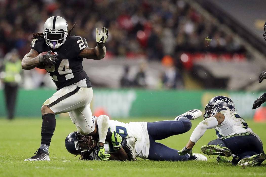 Oakland Raiders running back Marshawn Lynch (24) is tackled by Seattle Seahawks cornerback Shaq ...