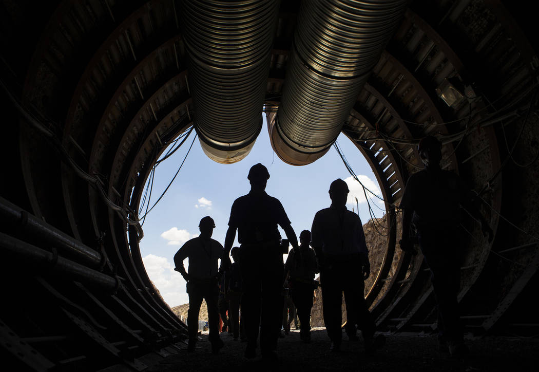 Members of a congressional tour make their way through the south portal of Yucca Mountain near ...