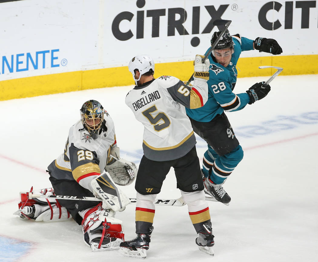 Golden Knights goaltender Marc-Andre Fleury (29) lets a puck get by him as Knights defenseman D ...
